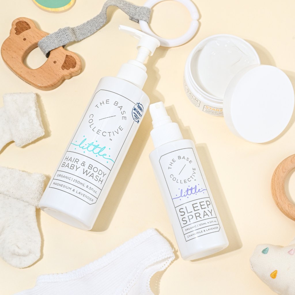Baby wash, Lavender Sleep Spray and Magnesium cream lying on yellow background with toys around.