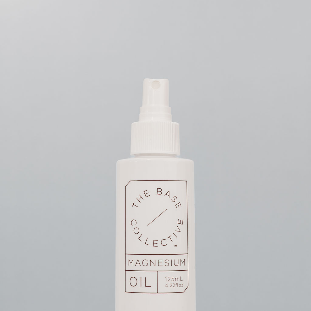 Magnesium Oil Spray against light blue background