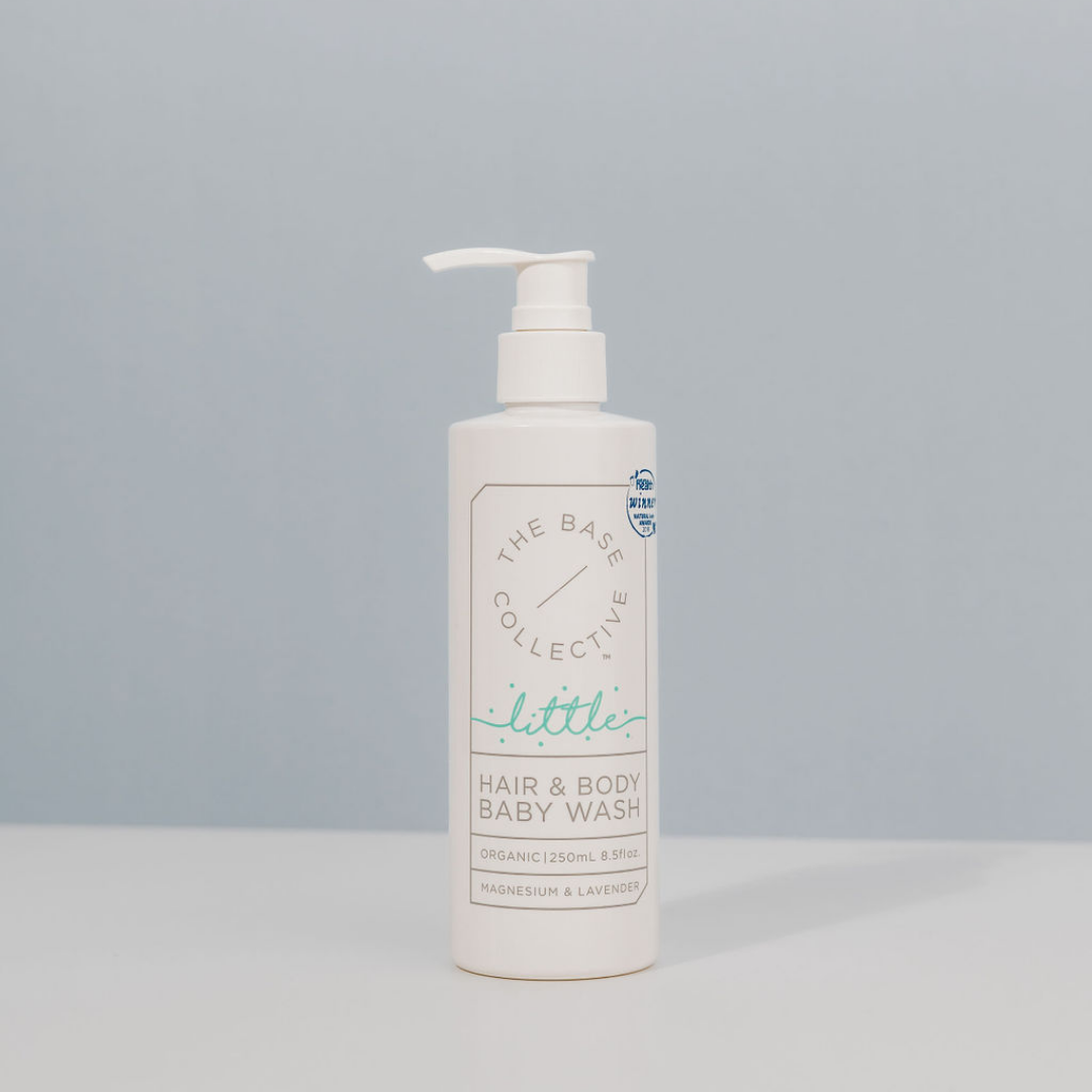 Organic Baby Wash by The Base Collective against a blue background