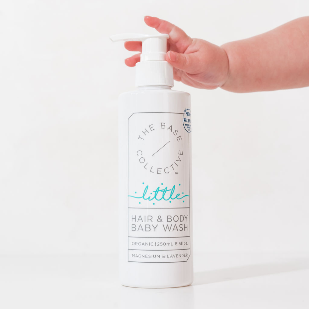 Little by The Base Collective Baby Wash with baby hand aching it on white background