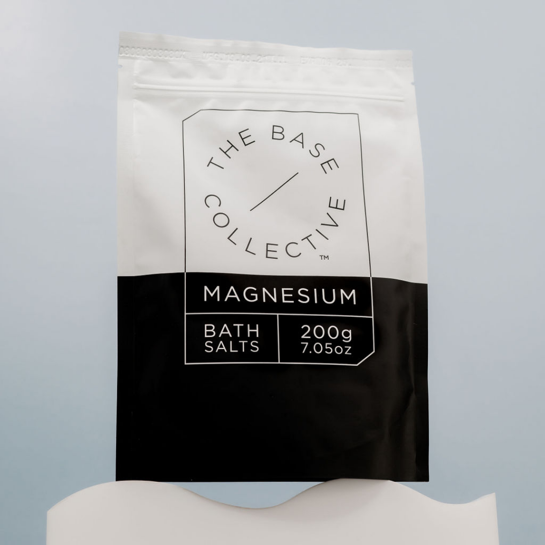 Magnesium Chloride Flakes by The Base Collective on wave stand against blue background.