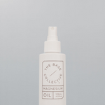 Magnesium Oil Spray against light blue background