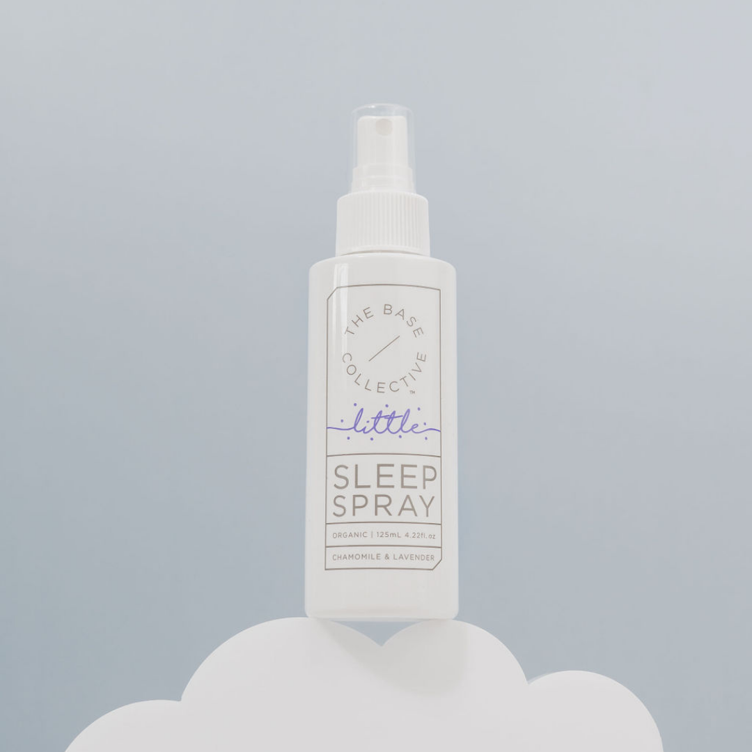 Lavender Sleep Spray by The Base Collective on a cloud against a light blue background