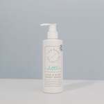 Organic Baby Wash by The Base Collective against a blue background